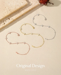 Detailed view of three elegant clover bracelets in rose gold, gold, and silver finishes