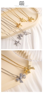 Detail shot of bow-shaped pendant necklace with sparkling cubic zirconia in gold and silver