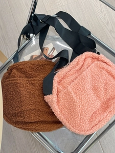 Brown and pink fuzzy sherpa crossbody bags with adjustable wide shoulder straps