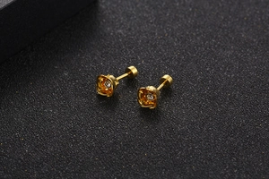 Detailed view of gold-plated rose stud earrings with a sparkling central zircon inlay
