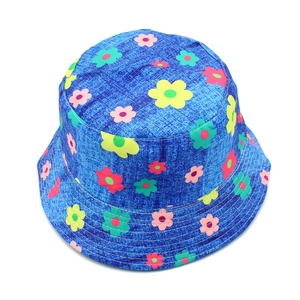 Detailed view of blue bucket hat featuring multi-colored floral patterns and reinforced brim