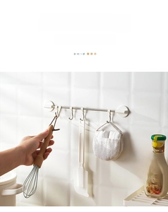 Detail of adjustable kitchen wall rack with movable hooks for non-drill storage