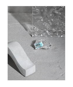 Detail of silver lava texture ring featuring a rectangle light blue zircon stone