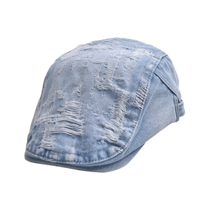 Vintage distressed denim beret with frayed holes and washed light blue street style finish