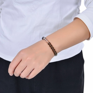 Handcrafted 8mm Tiger Eye and Citrine beaded bracelet worn on a female wrist
