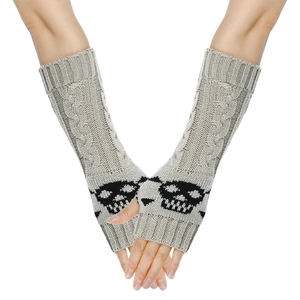 Detail of beige knit arm warmers with black skull pattern and fingerless design