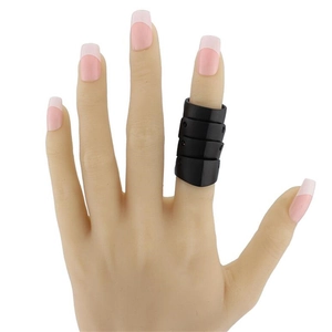Detail view of a black finger joint support protector on a model hand with pink nails