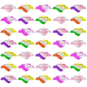 Close-up of heart-shaped push bubble sensory toys with wings in colorful gradient colors