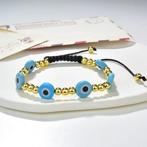 Handmade evil eye bead bracelet with gold copper beads and adjustable black braided cord