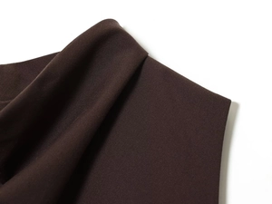 Detailed macro shot of dark brown ruched fabric texture and dense premium weave