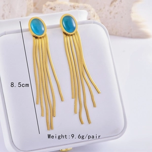 Detail view of long gold tassel earrings with blue stones, measuring 8.5cm in length