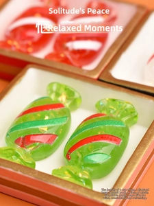 Macro view of miniature resin candy ornaments with gold leaf inside a tray