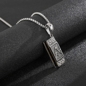 Detailed view of silver rectangular Freemason pendant with G symbol on box chain necklace