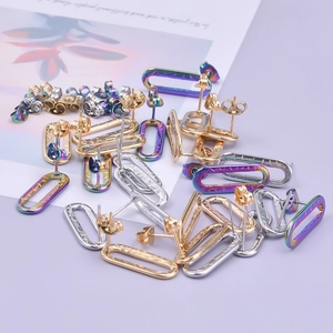 Close-up of geometric stainless steel oval hoop earrings in gold silver and rainbow colors