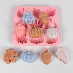 Macro detail of 9-cavity silicone mold with pumpkin and leaf shapes for DIY crafting