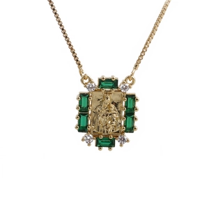 Gold pendant necklace with square embossed figure, green and clear zircon stones on white
