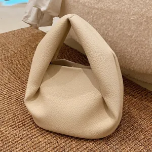 Minimalist beige pleated cloud handbag with integrated handle for daily commute