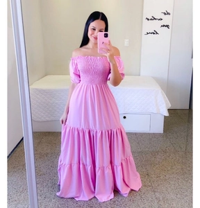 Detail of pink smocked off-shoulder dress with tiered skirt and puff sleeves