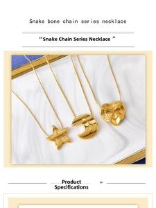 Close-up of gold snake bone necklace featuring star, moon, and heart textured pendants