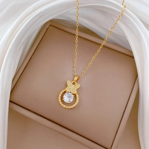 Elegant gold butterfly ring pendant necklace with crystals on white silk background