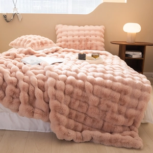 Close-up of pink faux fur blanket featuring premium soft 3D bubble texture and plush feel