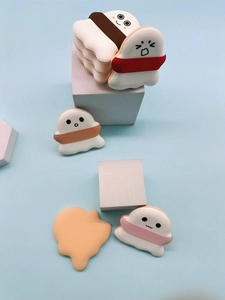 Detail showing five cute cartoon marshmallow-style air cushion puffs in various colors