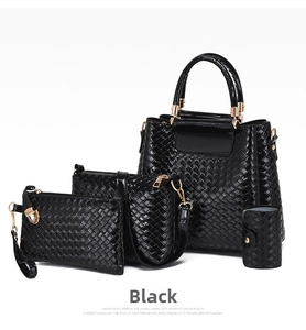 Detail of 4-piece black tote set with woven pattern and premium golden metal hardware
