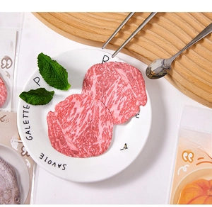 Creative realistic raw meat sliced sticky notes displayed on a white ceramic dining plate