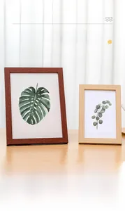 Detail of minimalist wooden photo frames in dark and light finishes for desktop display
