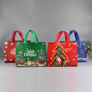 Close-up of vibrant Christmas non-woven gift bags with Santa and snowman patterns