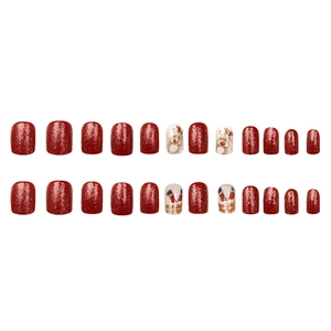 Christmas press-on nail set featuring red glitter, elk designs, and Santa Claus patterns