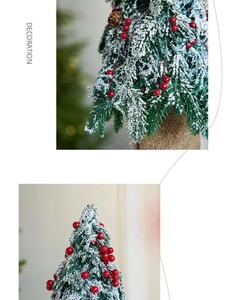 Macro detail of mini flocked Christmas tree with red berries and burlap base