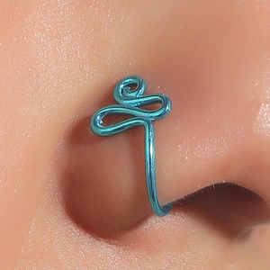 Detail shot of a blue coiled non-pierced U-shaped nose cuff with spiral wire design