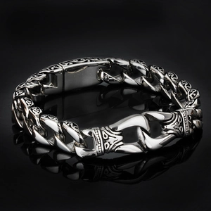 Detail of vintage silver engraved chain bracelet with retro pattern on black surface