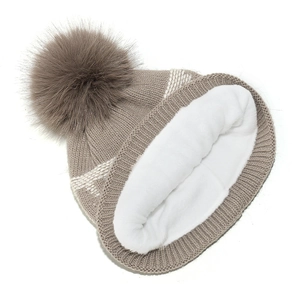 Detailed view of the thick white fleece lining inside a knitted winter beanie hat