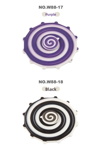 Detail view of purple and black spiral patterns on dual-sided rainbow fidget spinners
