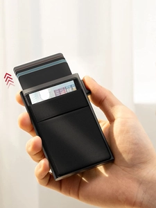 Close-up of black RFID metal wallet with automatic pop-up mechanism and card slots