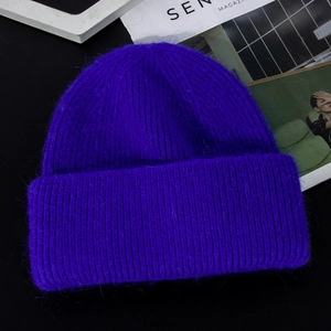 Close-up of bright purple knit beanie showing long rabbit hair texture and thick warmth