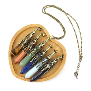 Set of six hexagonal natural crystal stone pendants with vintage bronze metal caps in a tray