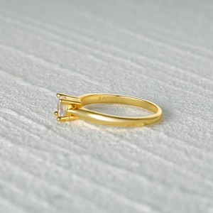Detailed view of S925 hallmark on gold plated sterling silver ring with four-prong stone