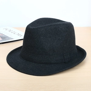 Men's dark grey wool felt fedora hat with decorative band on a light wood surface