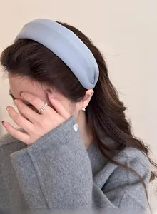 Detail of light blue padded headband worn with a wool coat for a stylish autumn look