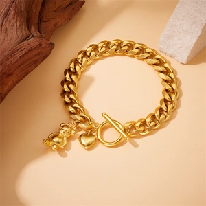 Gold-plated stainless steel Cuban link bracelet with bear and heart charms featuring OT toggle