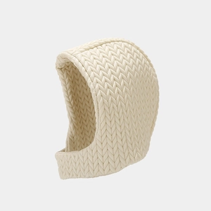 Detailed view of cream-colored cable knit balaclava showing thick textured weave and warmth