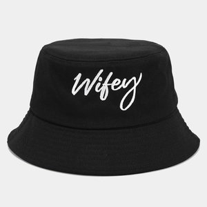 Detail of white Wifey embroidery on black cotton canvas bucket hat with refined texture