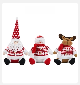 Detailed front view of knit Santa, Snowman, and Reindeer plush dolls with wooden buttons