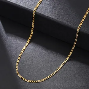 Macro detail of a golden flat link chain necklace resting on a black jewelry box