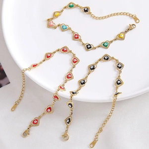 Gold evil eye heart charm bracelet with colorful enamel details and adjustable chain