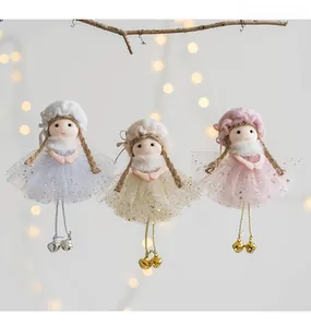 Detailed view of handmade plush Christmas angel ornaments with sequins and bells on a branch