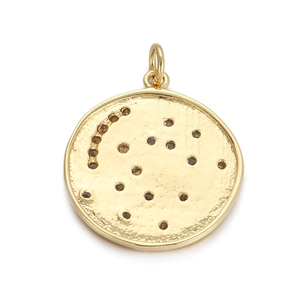 Detailed view of a gold-plated round pendant featuring an engraved constellation pattern